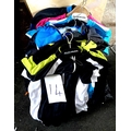 A quantity of cycling apparel, mostly men's jerseys.