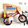 A KiddiMoto children's wooden balance bike, red 'Fire' engine colours, red seat, together with a mat... 
