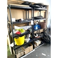 A pair of black plastic shelving units, with contents, including a quantity of child's bike tyres, a... 