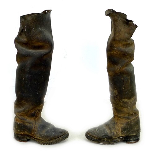 89 - A pair of early 20th century thigh high black leather farm boots, with metal studded soles and heels... 