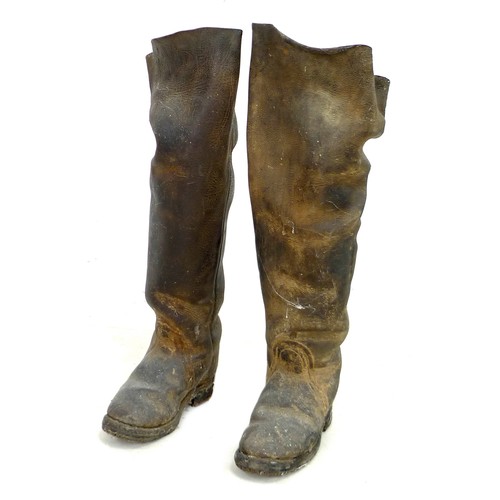 89 - A pair of early 20th century thigh high black leather farm boots, with metal studded soles and heels... 