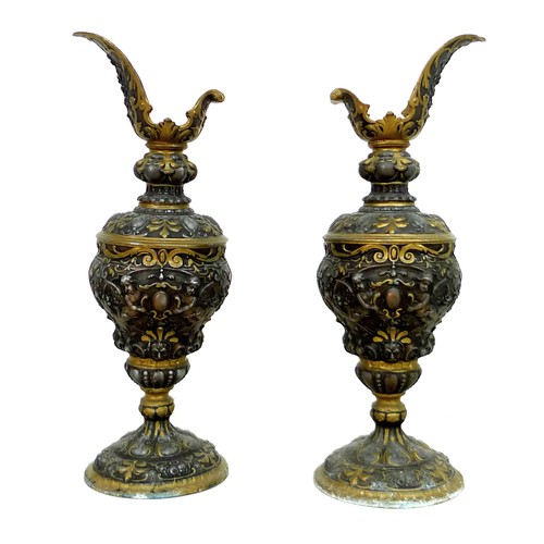 90 - A pair of early to mid 20th century metal ewers, a/f missing handles, in Italian style decorated in ... 