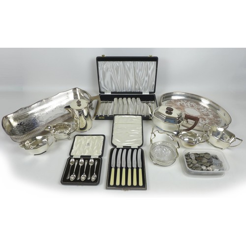 99 - A group of silver plated items, including two trays, three piece tea service, sauce boats, cased set... 