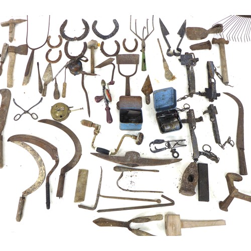 102 - A group of vintage hand tools, including a hoe, a rake, hammers, shears, sickles, hand drill, and tw... 