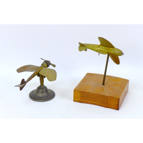 106 - Seven cast metal models of WWI and later aircraft, including a brass Spitfire, 15 by 12 by 3cm high,... 