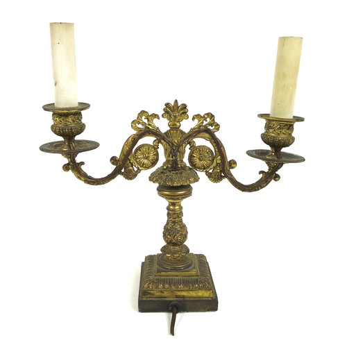 100A - A French late 19th century gilt metal twin branch table lamp, with floral scrolling decoration and c... 