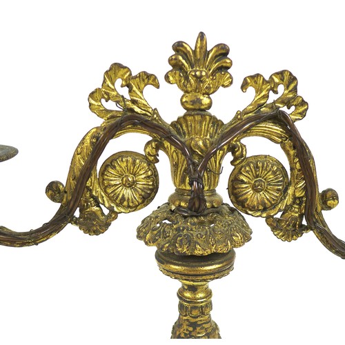 100A - A French late 19th century gilt metal twin branch table lamp, with floral scrolling decoration and c... 