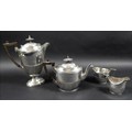 A George V four piece silver tea service, all with half reeded lower bodies, comprising a teapot wit... 