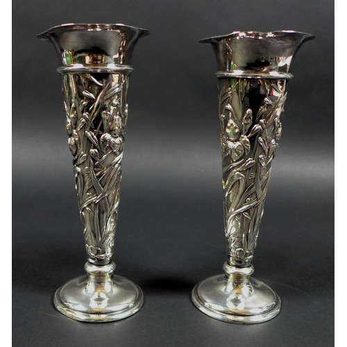 16 - A pair of Victorian silver spill vases, with flared rims and enbossed floral designed stems and weig... 