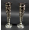 A pair of Victorian silver spill vases, with flared rims and enbossed floral designed stems and weig... 