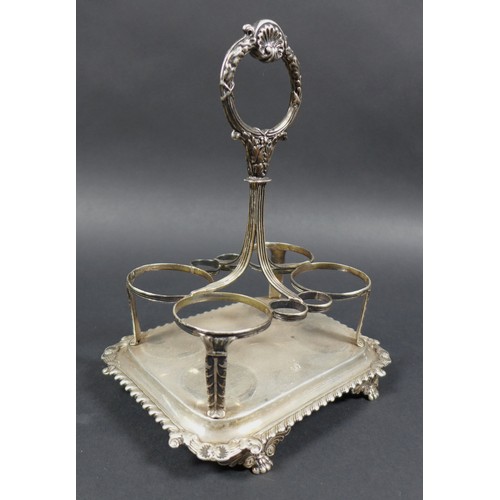 23 - A George III silver cruet stand, with shell mounted handle, monogram to base and scroll decorated ri... 