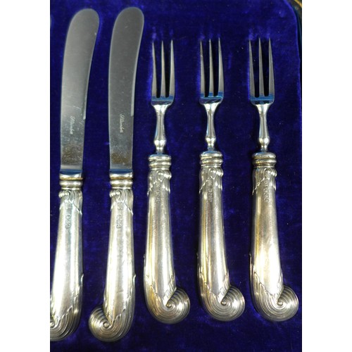 31 - A set of six silver pistol handled dessert knives and forks, George Howson, Sheffield 1912, stainles... 