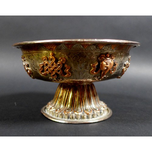 11 - Two similar Tibetan copper and silver plated footed bowls, 19th or early 20th century, decorated wit... 