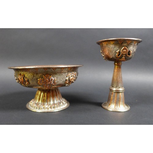 11 - Two similar Tibetan copper and silver plated footed bowls, 19th or early 20th century, decorated wit... 