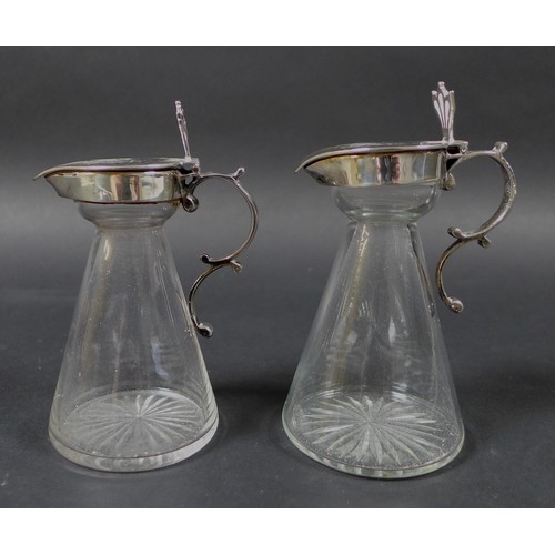 34 - A pair of Edwardian clear glass and silver mounted noggin flasks, each of tapering form with mounted... 