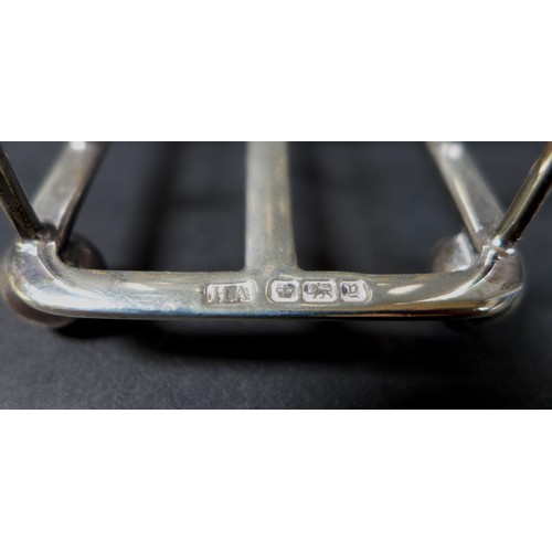 19 - A group of Edwardian and later silver, comprising two silver toast racks, one Atkin Brothers, Sheffi... 