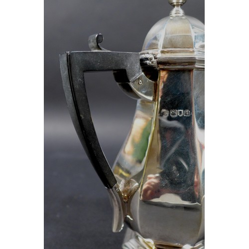 26 - A George V silver coffee pot, of octagonal form with ebonised handle and stepped base, Goldsmiths & ... 