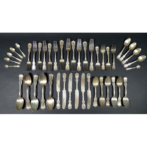 50 - An early 20th century American Sterling silver suite of cutlery, with faddle pattern fancy C scroll ... 