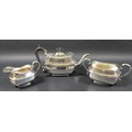 An Edward VII silver three piece tea service, of London shape, comprising teapot with ebonised woode... 