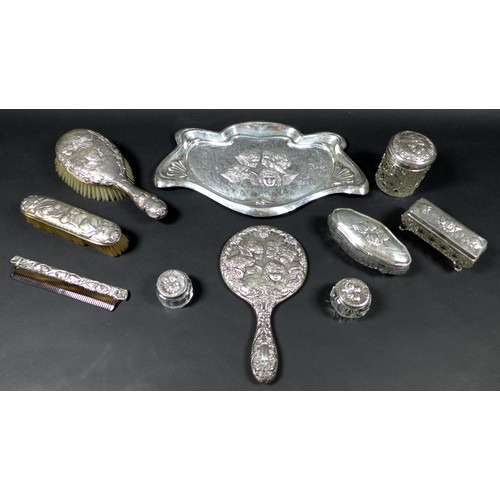 36 - Ten pieces of Edwardian silver dressing table items, all decorated with repousse cherubs after Joshu... 