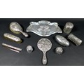 Ten pieces of Edwardian silver dressing table items, all decorated with repousse cherubs after Joshu... 