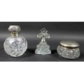 Three silver topped dressing table items, inclduing a spherical scent bottle with hinged silver top ... 