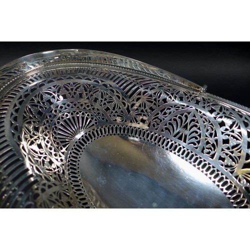 48 - A Victorian silver swing handled fruit basket, the pierced sides decorated with friezes of leaves an... 