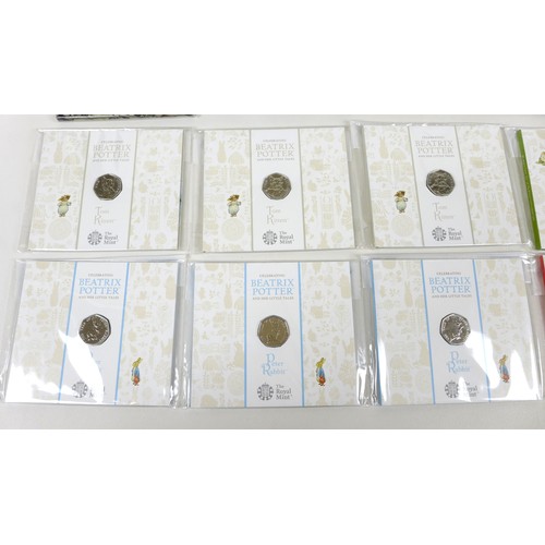 102 - A collection of Elizabeth II Royal Mint brilliant uncirculated 50p coins, including two Beatrix Pott... 