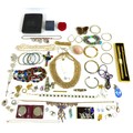 A group of costume jewellery, comprising necklaces, brooches, earrings, bangles, rings, coins and a ... 