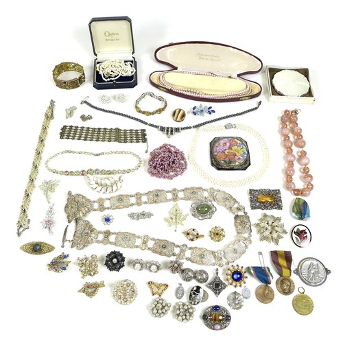 244 - A group of costume jewellery and medals, including compacts, faux pearl necklaces, silver brooches, ... 