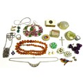 A small group of costume jewellery, including pill boxes, an amber style necklace, and various brooc... 