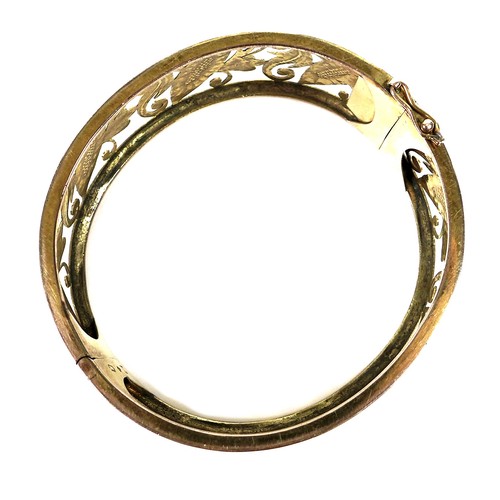 371 - A 14ct gold openwork bangle, hinge clasp, 6 by 6.4 by 2.2cm, 32.3g.