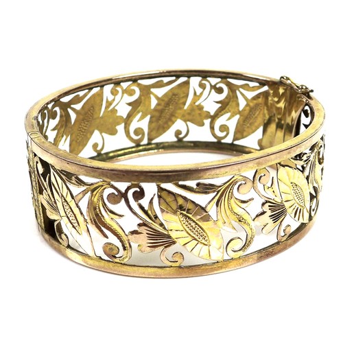 371 - A 14ct gold openwork bangle, hinge clasp, 6 by 6.4 by 2.2cm, 32.3g.