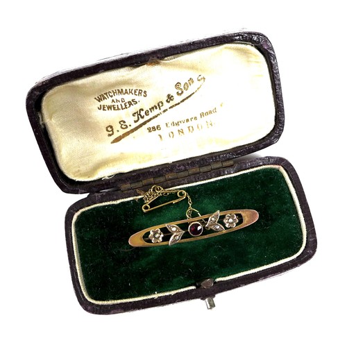 245 - A 9ct gold, ruby and seed pearl brooch, 4cm long, with safety chain, 2.9g, boxed, together with a go... 