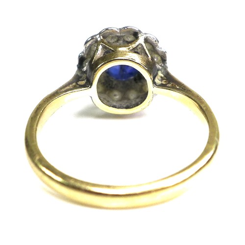 364 - An 18ct yellow gold and platinum, sapphire and diamond flowerhead ring, the central oval cut Royal b... 