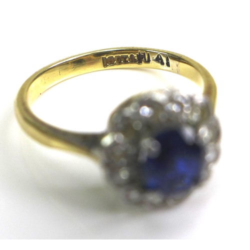 364 - An 18ct yellow gold and platinum, sapphire and diamond flowerhead ring, the central oval cut Royal b... 