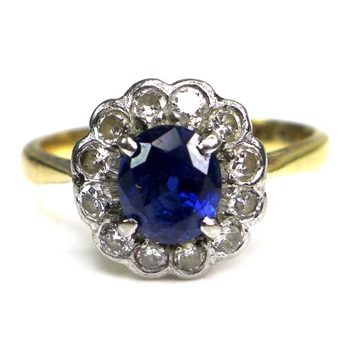 364 - An 18ct yellow gold and platinum, sapphire and diamond flowerhead ring, the central oval cut Royal b... 