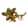 An 18ct gold brooch in the shape of an orchid, set with a pearl to the centre, 3.8cm long, safety ch... 