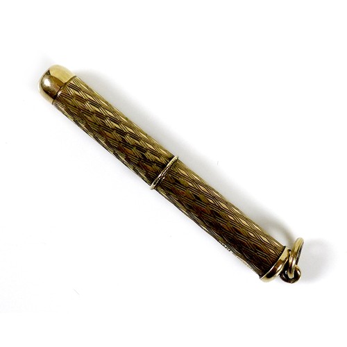 254 - A 9ct gold propelling cigar piercer, with ring suspension and engraved decoration to the cylindrical... 