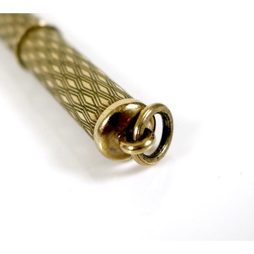 254 - A 9ct gold propelling cigar piercer, with ring suspension and engraved decoration to the cylindrical... 