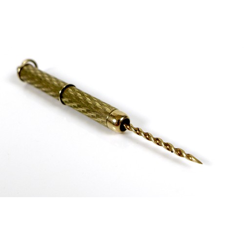 254 - A 9ct gold propelling cigar piercer, with ring suspension and engraved decoration to the cylindrical... 