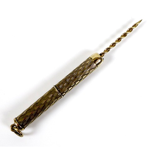 254 - A 9ct gold propelling cigar piercer, with ring suspension and engraved decoration to the cylindrical... 