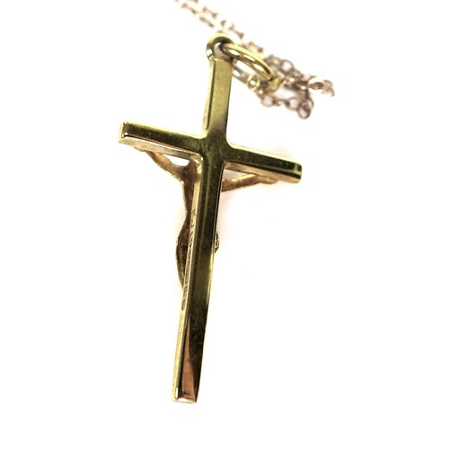 255 - A 9ct gold crucifix necklace, 2.7cm high, hallmarked, on an unmarked but tested 9ct gold chain, and ... 