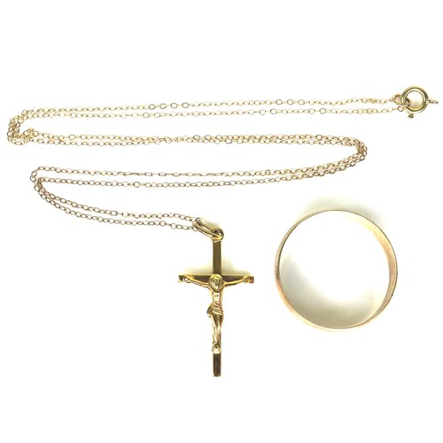 255 - A 9ct gold crucifix necklace, 2.7cm high, hallmarked, on an unmarked but tested 9ct gold chain, and ... 