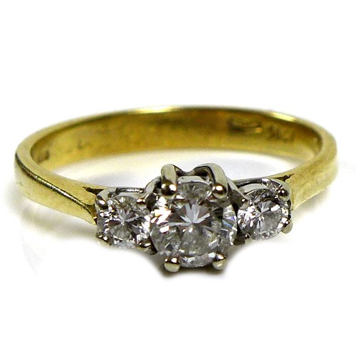 368 - An 18ct gold and diamond three stone ring, the central stone of approximately 4.3mm diameter and 0.2... 