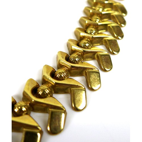 373 - An 18ct gold modern design necklace, stamped '750' the abstract S-shaped links joined by small spher... 