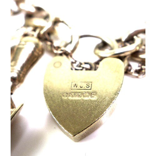 375 - A 9ct yellow gold charm bracelet, kerb link with heart padlock clasp, all links marked, fitted with ... 