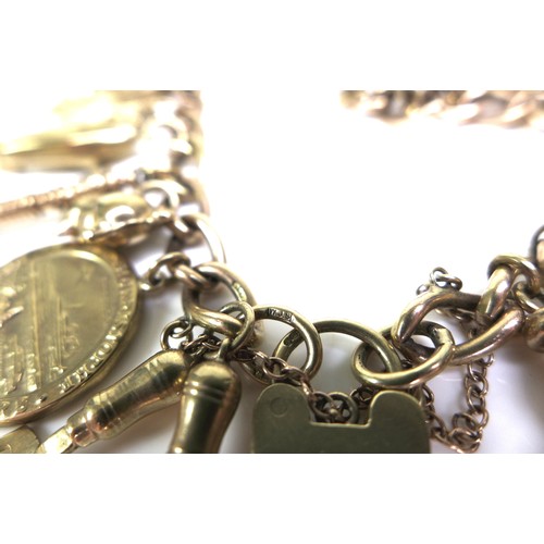 375 - A 9ct yellow gold charm bracelet, kerb link with heart padlock clasp, all links marked, fitted with ... 