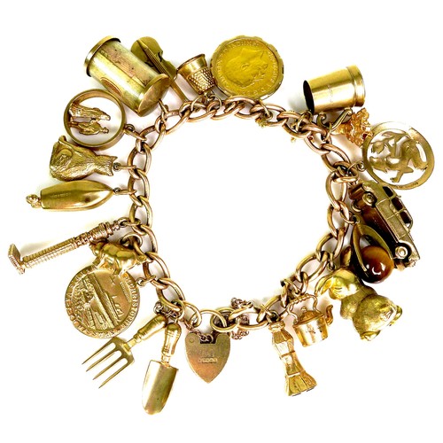 375 - A 9ct yellow gold charm bracelet, kerb link with heart padlock clasp, all links marked, fitted with ... 