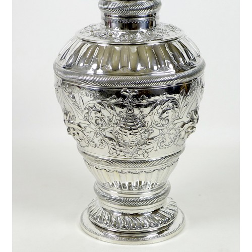 51 - A large and impressive 19th century silver paraffin lamp, of ovoid form with all over repousse decor... 